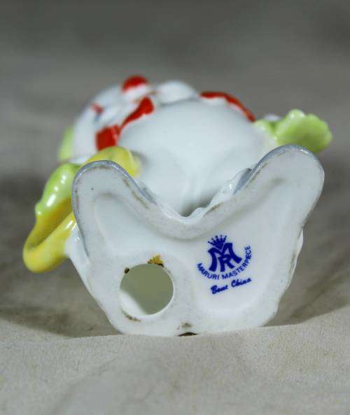 Maruri porcelain baby clown holding a large ring