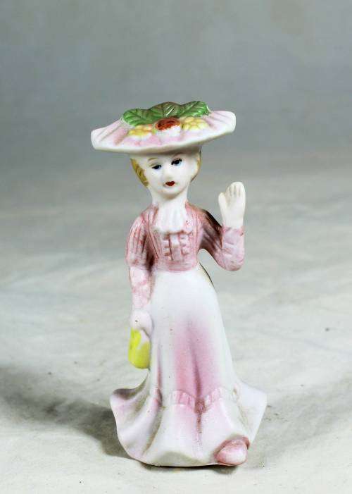 Miniature Victorian lady waving