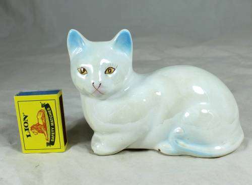 Porcelain cat lying down
