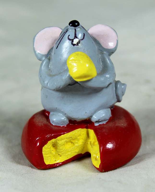 Miniature mouse on cheese