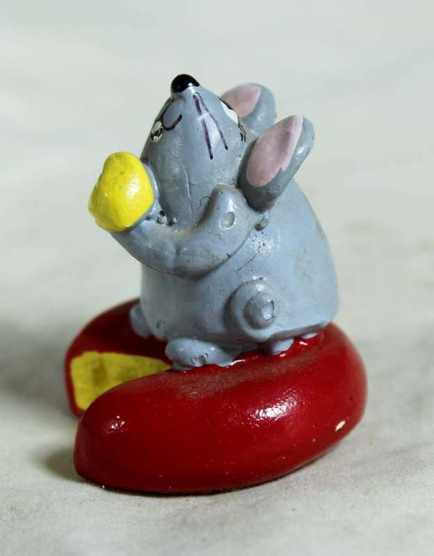 Miniature mouse on cheese
