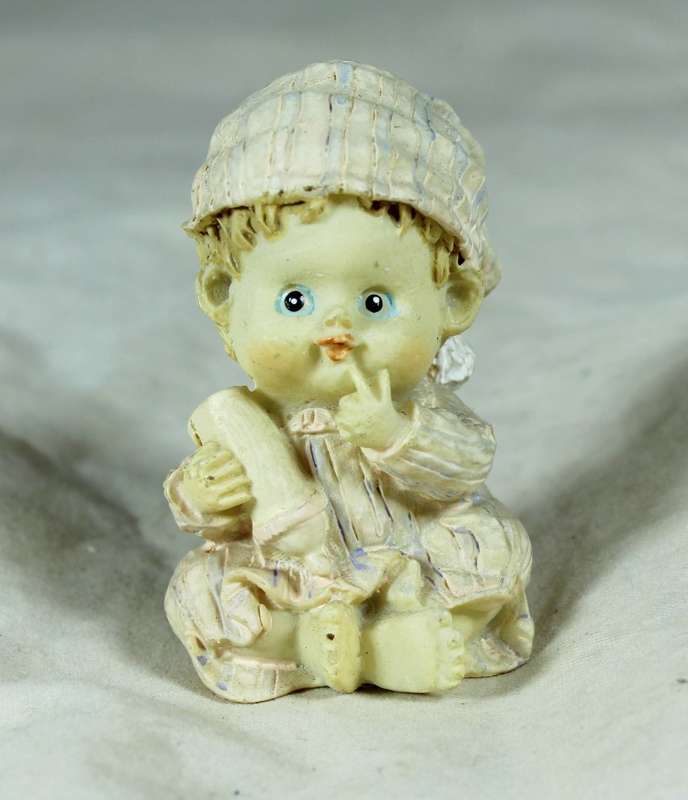 Small seated ceramic baby with bottle