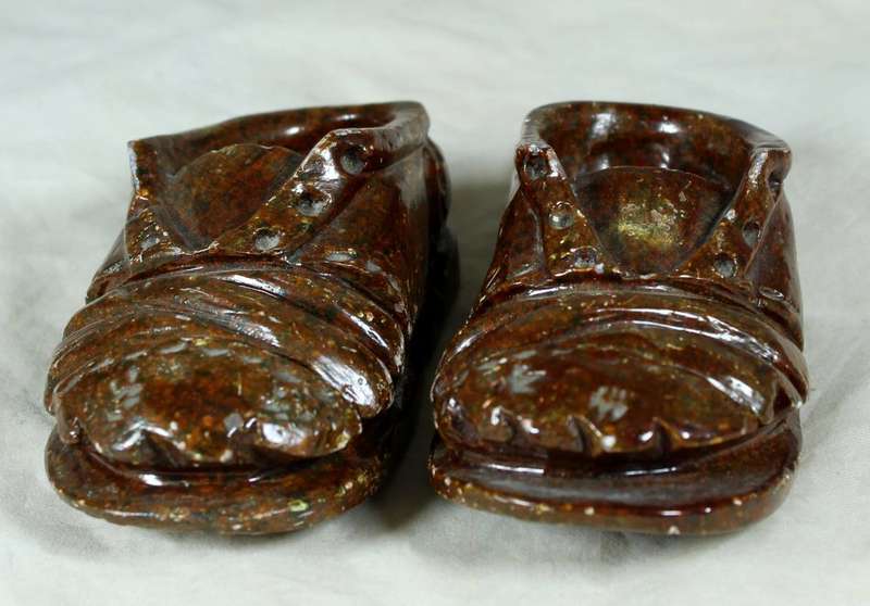 Small pair of worn stone shoes