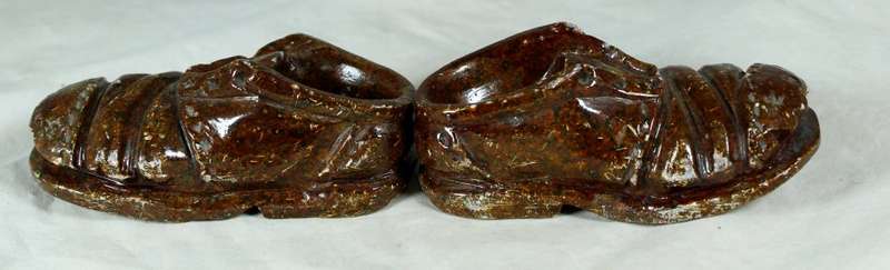Small pair of worn stone shoes