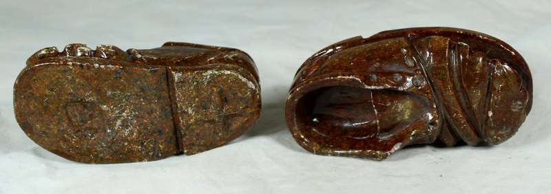 Small pair of worn stone shoes