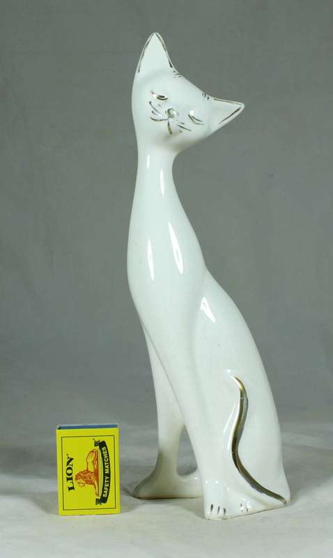Seated slim white cat