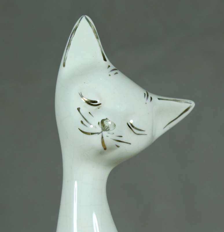 Seated slim white cat