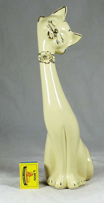 Tall seated cream cat