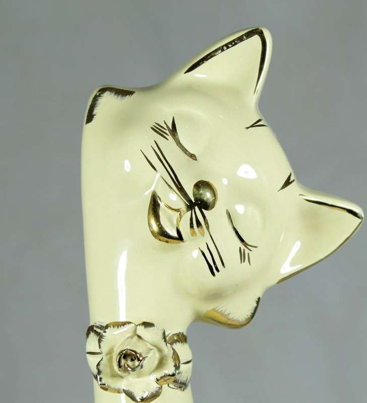 Tall seated cream cat