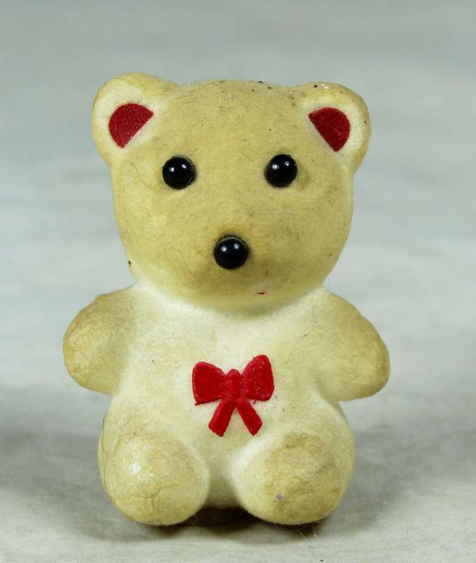 Miniature bear with a red bow tie