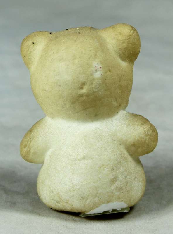 Miniature bear with a red bow tie