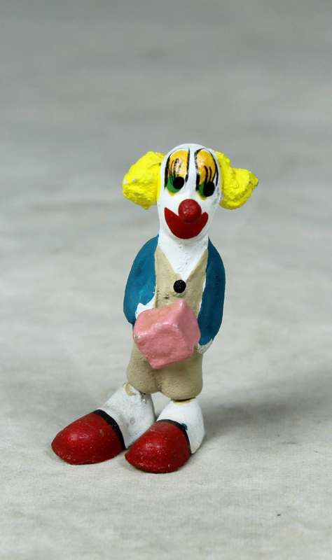 Miniature clown holding a present