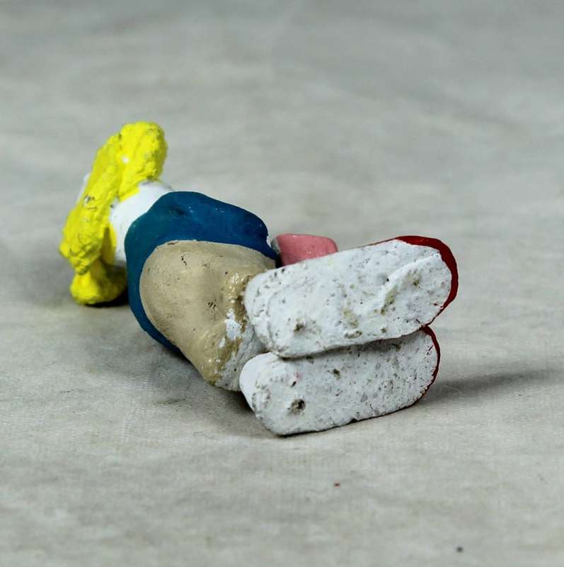 Miniature clown holding a present