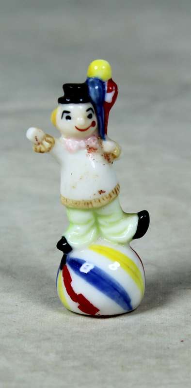 Miniature clown balancing a ball