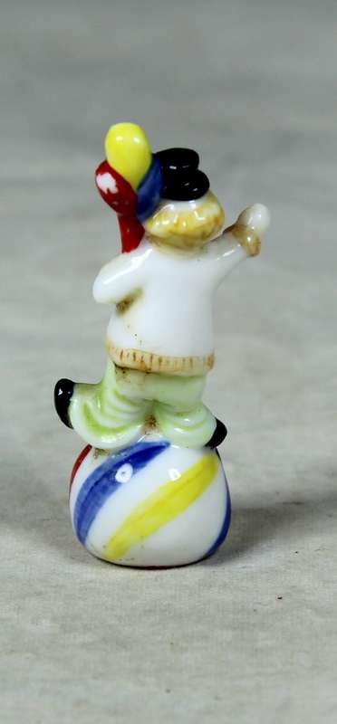 Miniature clown balancing a ball