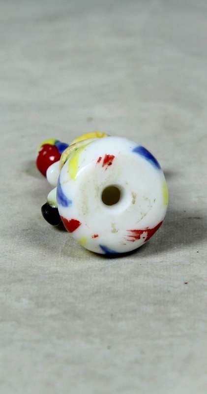 Miniature clown balancing a ball