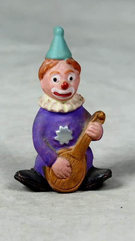 Miniature clown playing guitar