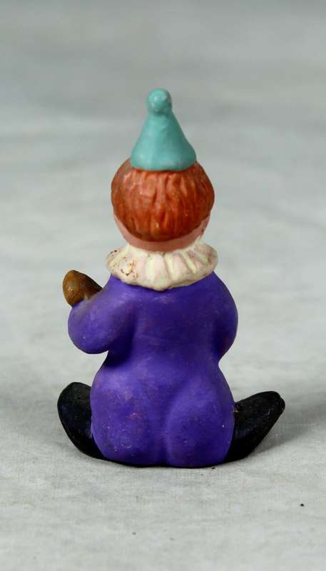 Miniature clown playing guitar