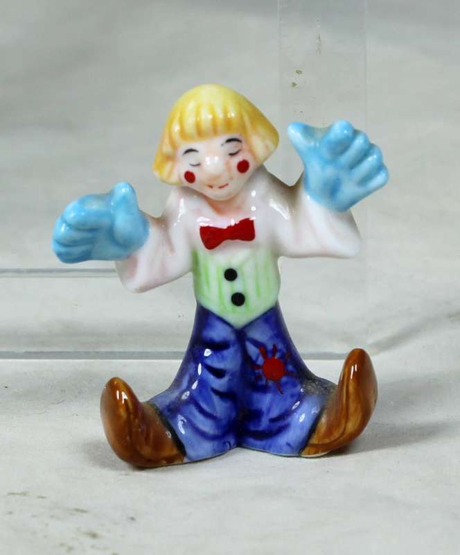 Miniature clown with large blue gloves