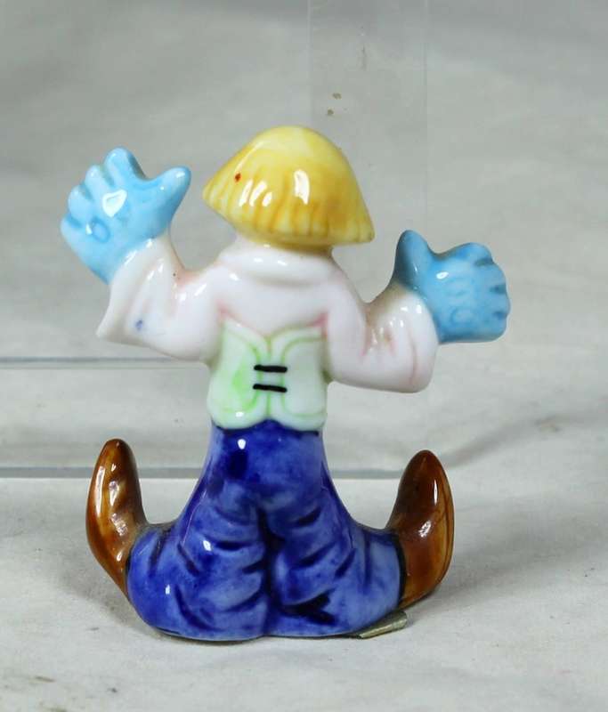 Miniature clown with large blue gloves