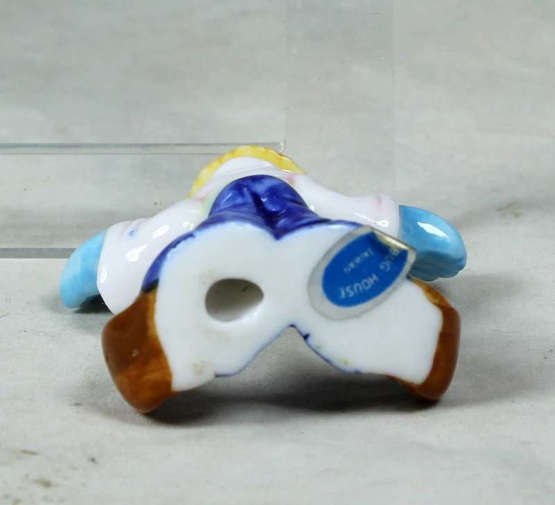 Miniature clown with large blue gloves