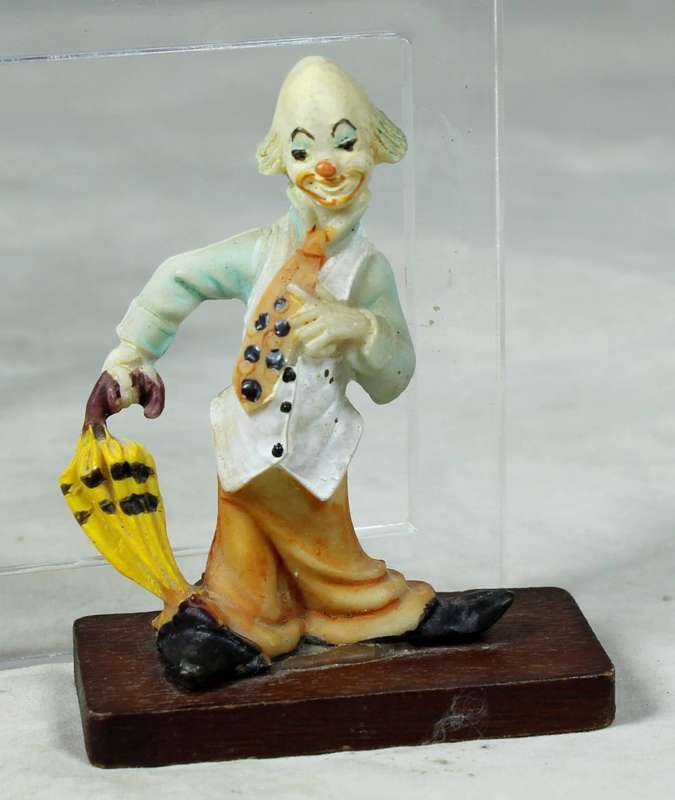 Miniature clown with an umbrella on a stand