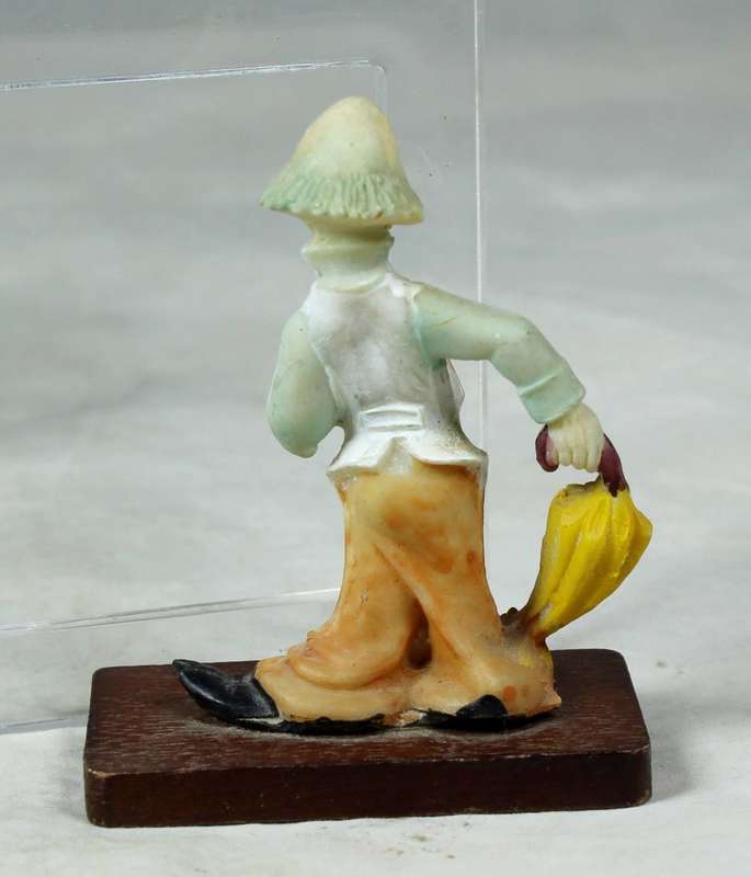 Miniature clown with an umbrella on a stand