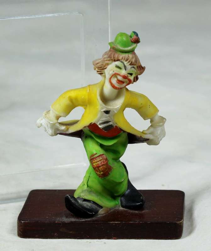 Miniature clown bowing down on a stand