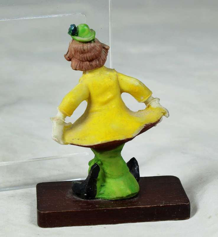 Miniature clown bowing down on a stand