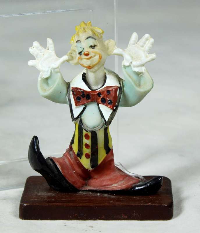 Miniature clown being silly on a stand