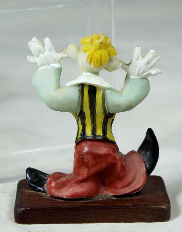 Miniature clown being silly on a stand