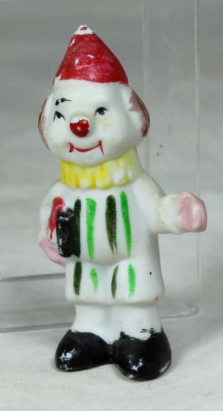 Miniature clown holding some books
