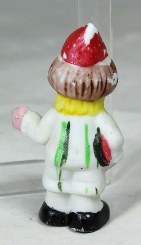 Miniature clown holding some books