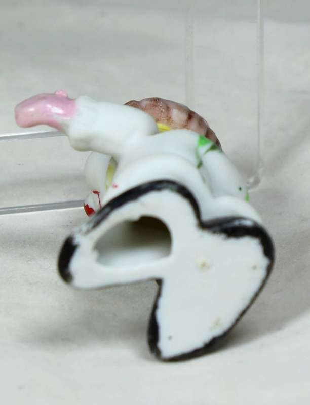 Miniature clown holding some books