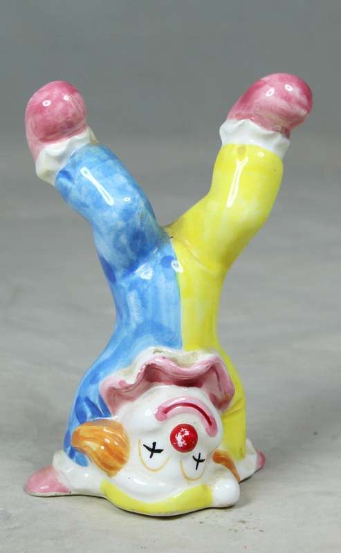 Small clown standing on his head