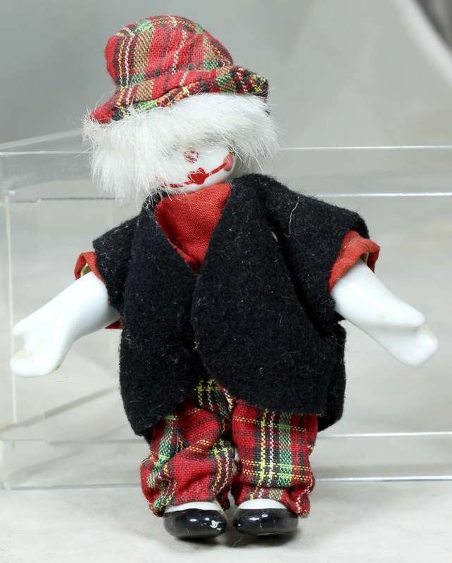 Small clown in a tartan pants and hat
