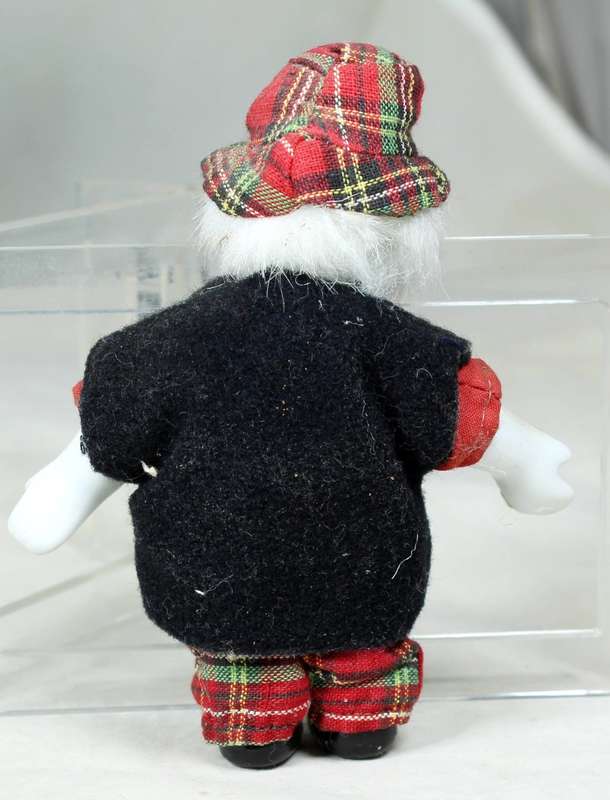 Small clown in a tartan pants and hat