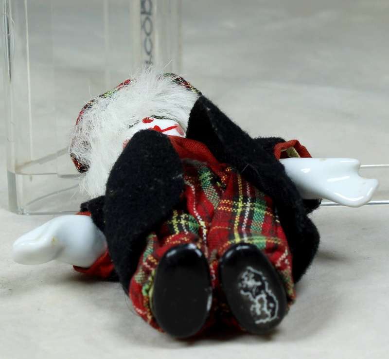 Small clown in a tartan pants and hat