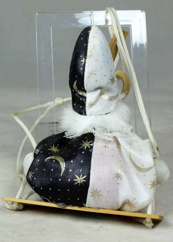 Small clown in a wizard jump suit on a swing