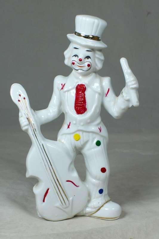 A CLOWN IN A POLKA DOT SUIT PLAYING A DOUBLE BASE GUITAR - BID NOW!!!