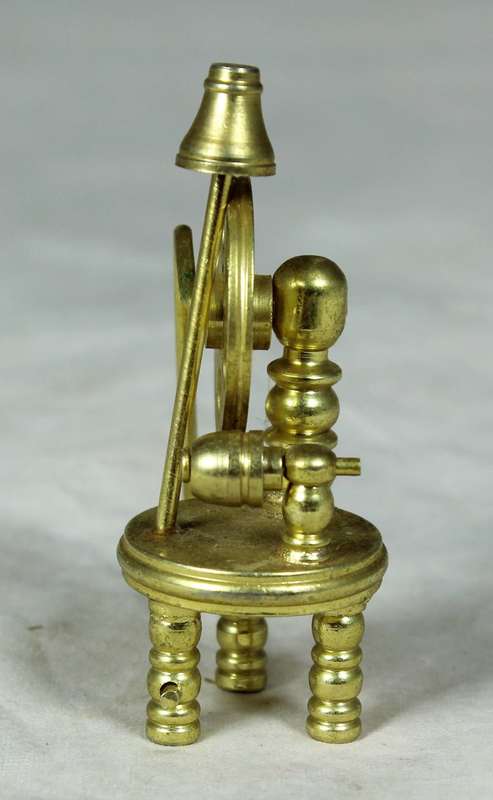 Miniature bronze spinning wheel