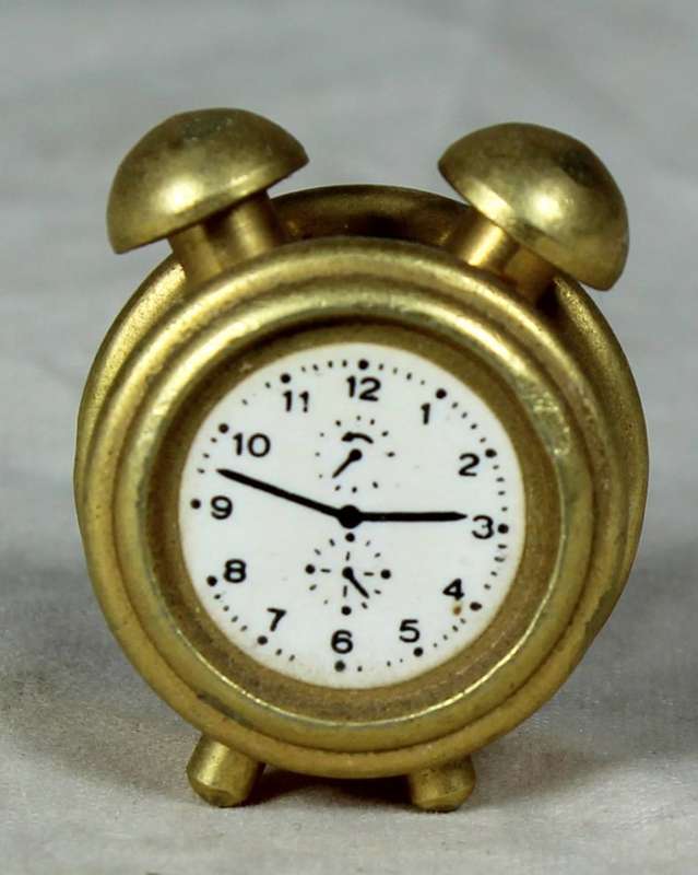 Miniature bronze alarm clock