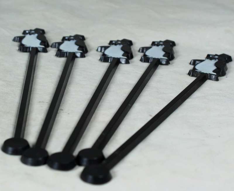 Five plastic penguin swizzel sticks