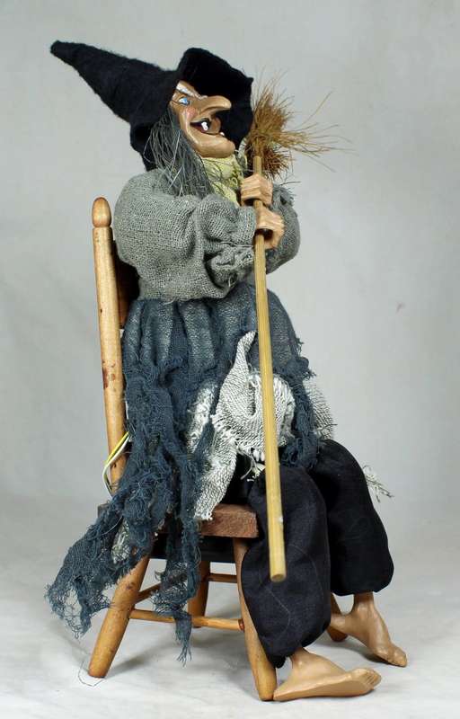 A LARGE WITCH SEATED ON A CHAIR-SHE TAPS HER FOOT AND HER EYES LIGHTS UP WHEN SWITCHED ON-BID NOW !!