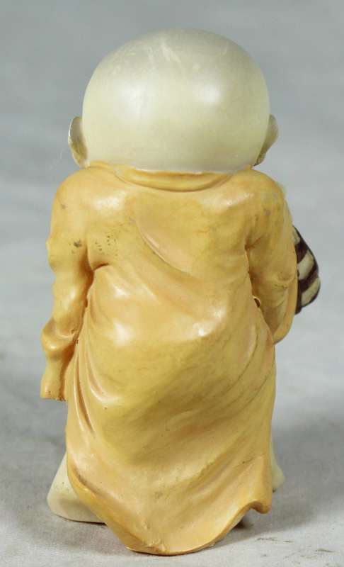 Baby Buddha - Carrying his Shoes and Sticking his Tongue Out