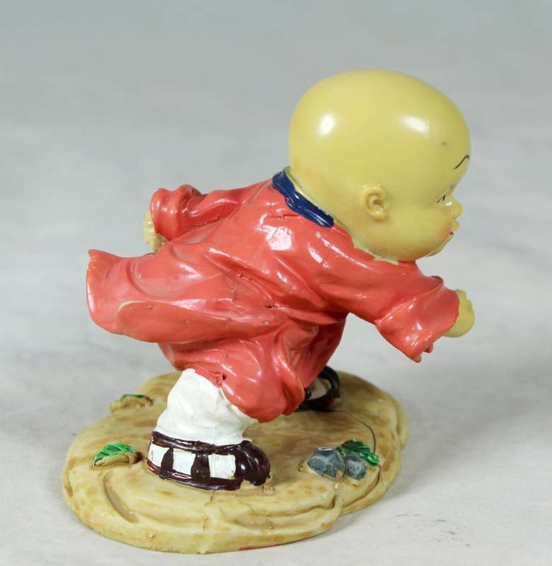 A baby Buddha - Monk practicing martial arts