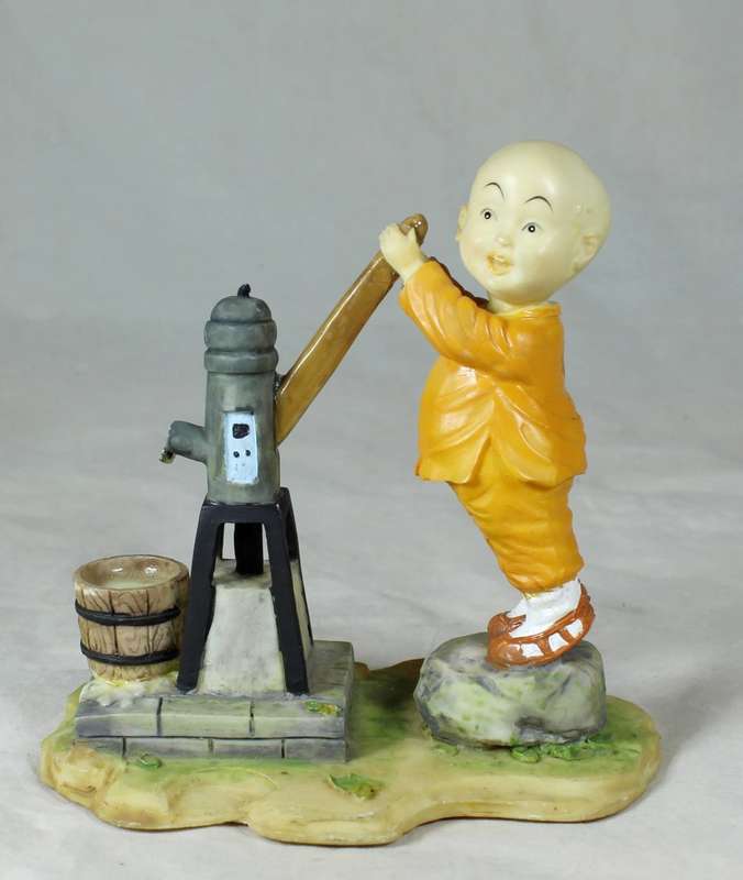 A baby Buddha - Monk pumping water