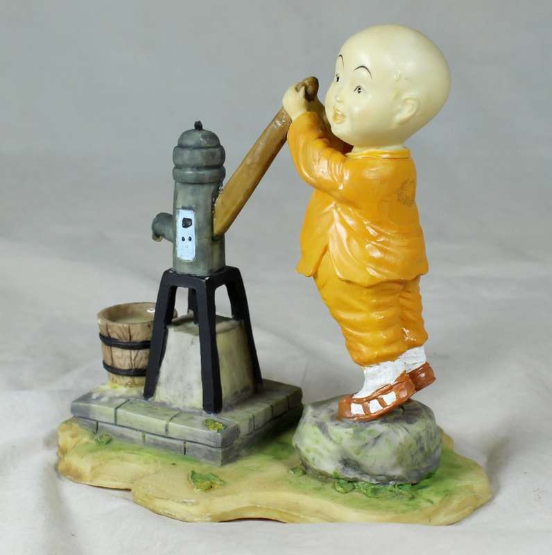 A baby Buddha - Monk pumping water