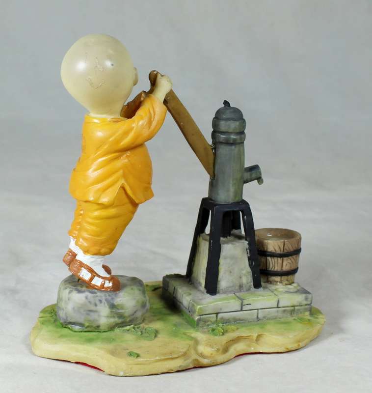 A baby Buddha - Monk pumping water