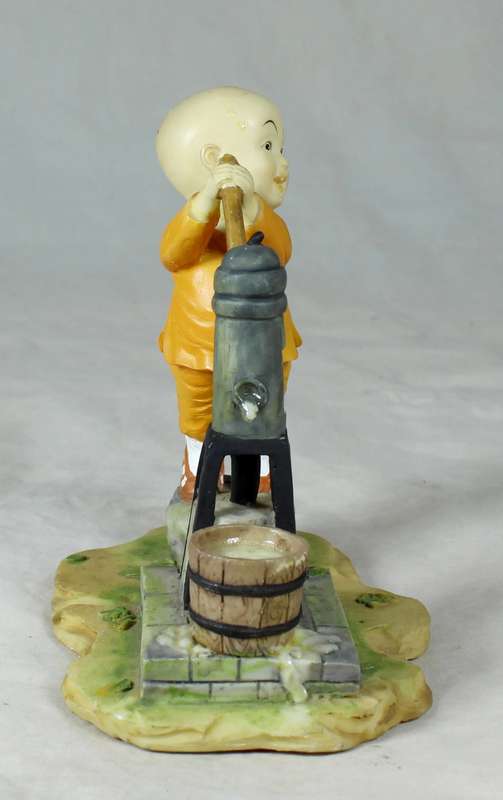 A baby Buddha - Monk pumping water